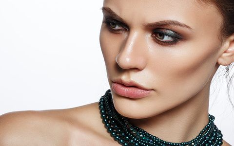 Elegant young lady with evening smart make up and beautiful necklace jewelry on her neck. Gorgeous woman face.