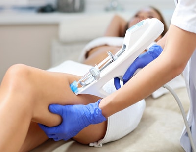 Picture of woman having leg mesotherapy in beauty salon