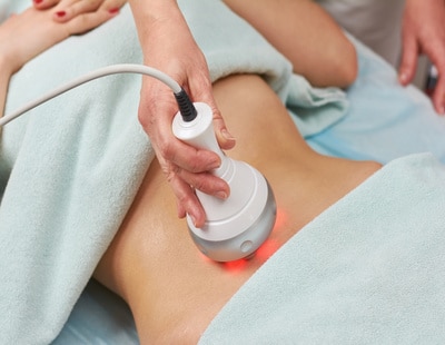 Radio frequency skin tightening machine. Belly of a woman, cosmetology.