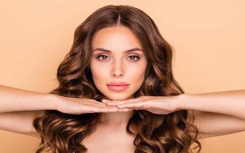 Close-up portrait of her she nice-looking attractive gorgeous well-groomed, sweet tender confident wavy-haired girl showing enhancement effect isolated over beige pastel color background