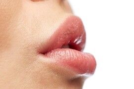 beauty, people, make-up and plastic surgery concept - close up of young woman lips