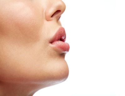 beauty, people, make-up and plastic surgery concept - close up of young woman lips