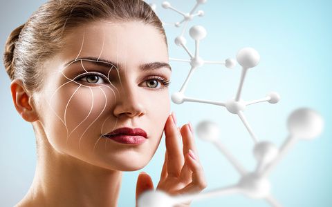 Young woman with lifting lines on face near big white molecule chain.