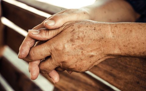 hands of a female elderly full of freckles
